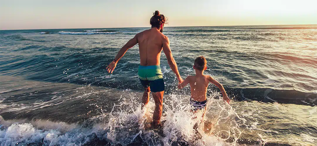 community father and son at beach