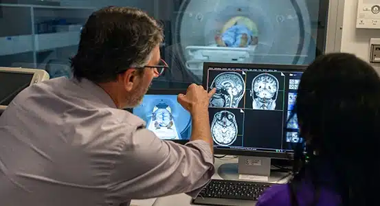 a man pointing at a computer screen