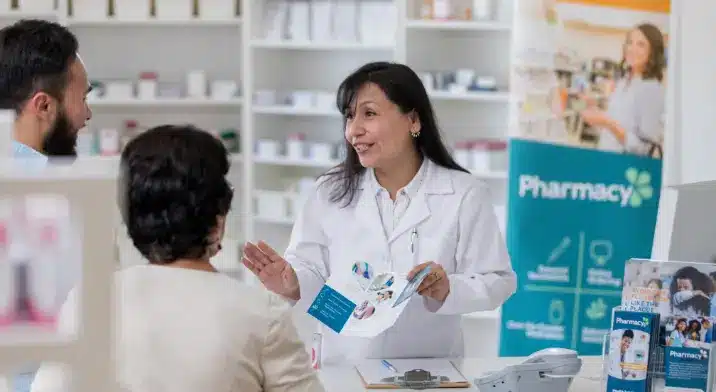 Pharmacist providing advice to cxustomers