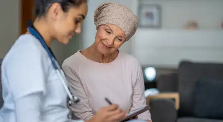 Lady who is undergoing cancer treatment with doctor