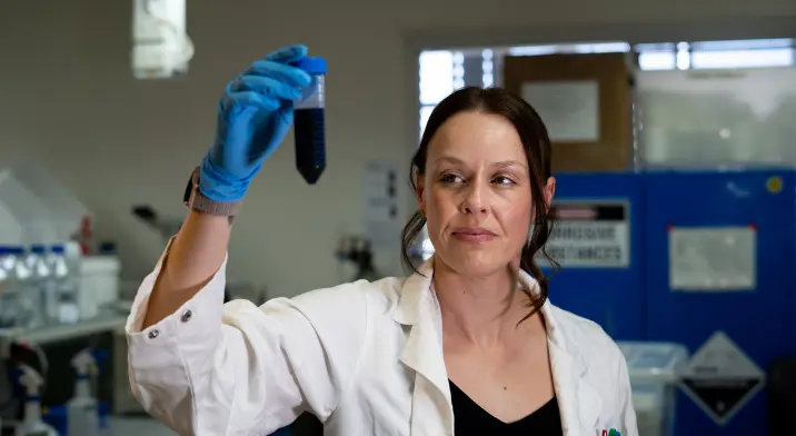 Dr Tessa Lord, holding a test tube