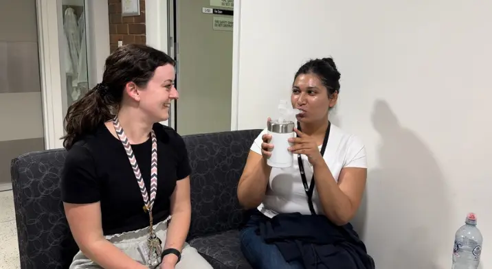 Two female researchers demonstrating lung cancer breathalyser concept